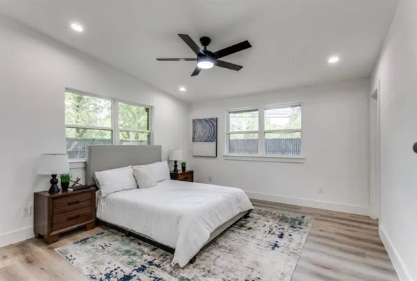 a bedroom with a bed and a window