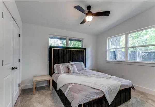 a bedroom with a large bed and a window