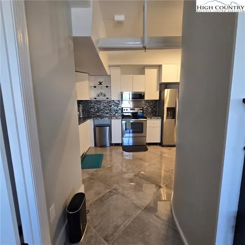 a kitchen with a sink and a refrigerator