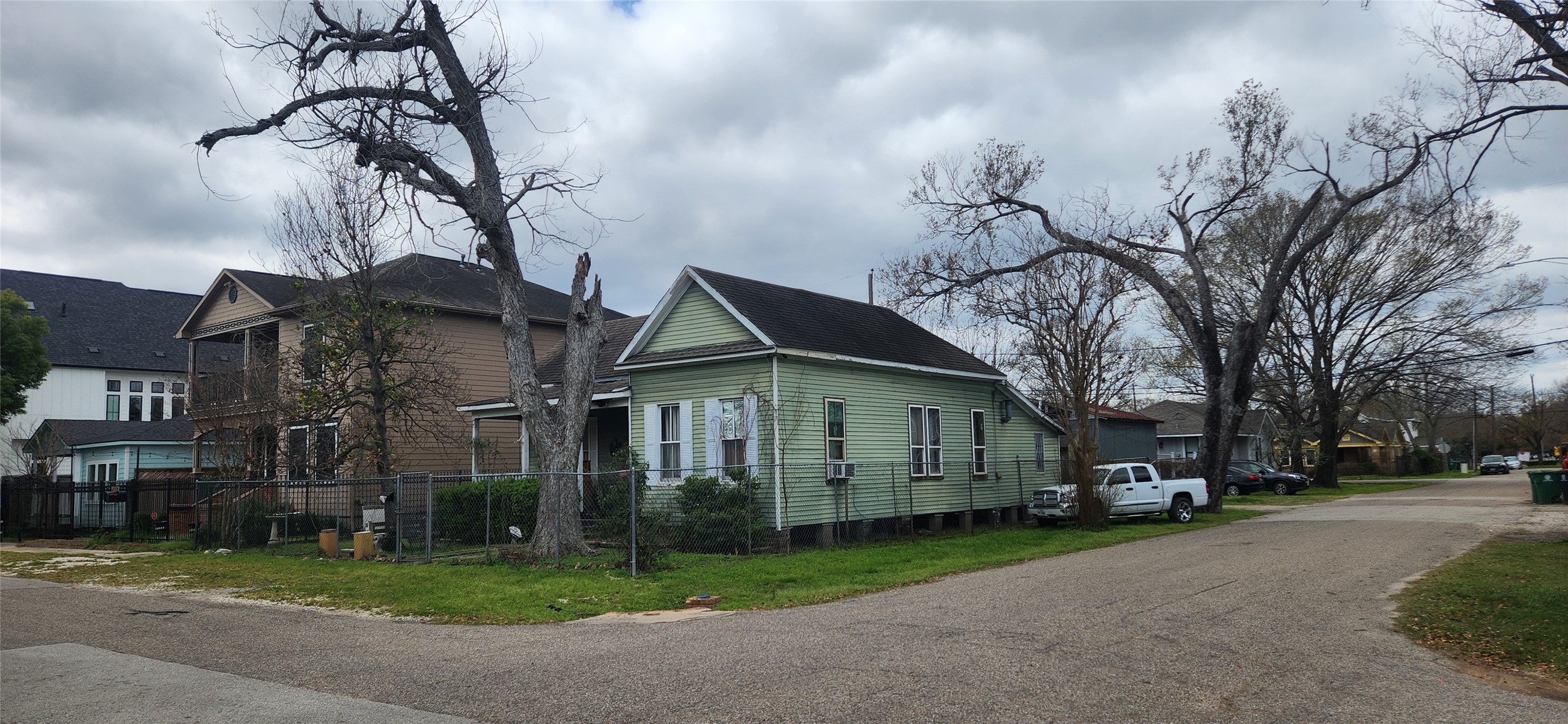 a front view of a house with a garden and trees