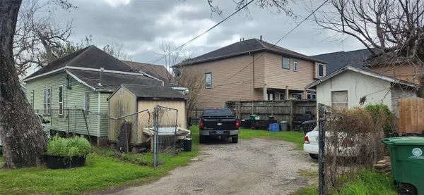 a view of a house with a patio and a yard