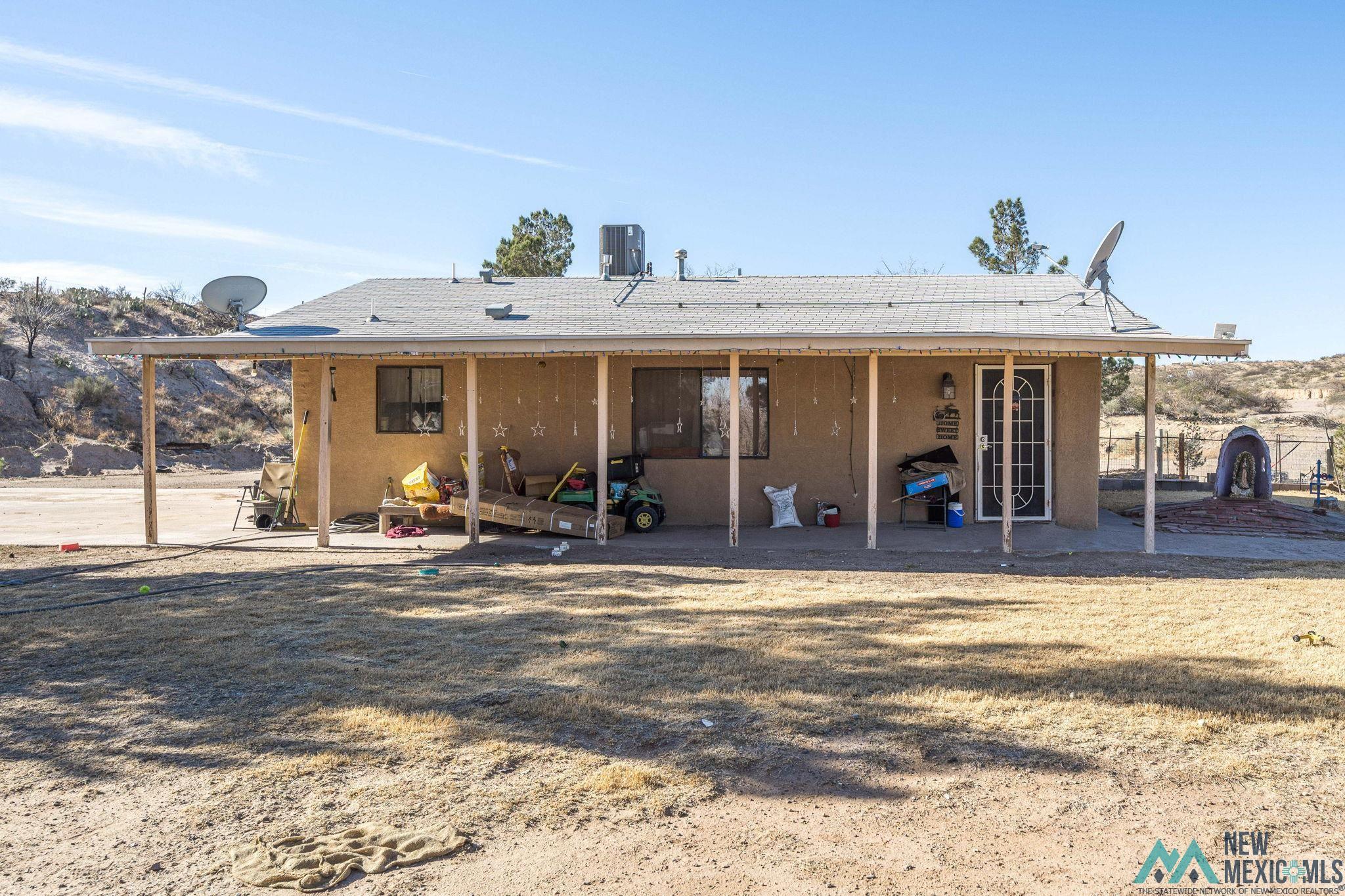 201 Squirrel Road Las Cruces, NM 88007 - Photo 20 of 25 Back of house featuring a patio, a shingled roof, and stucco siding