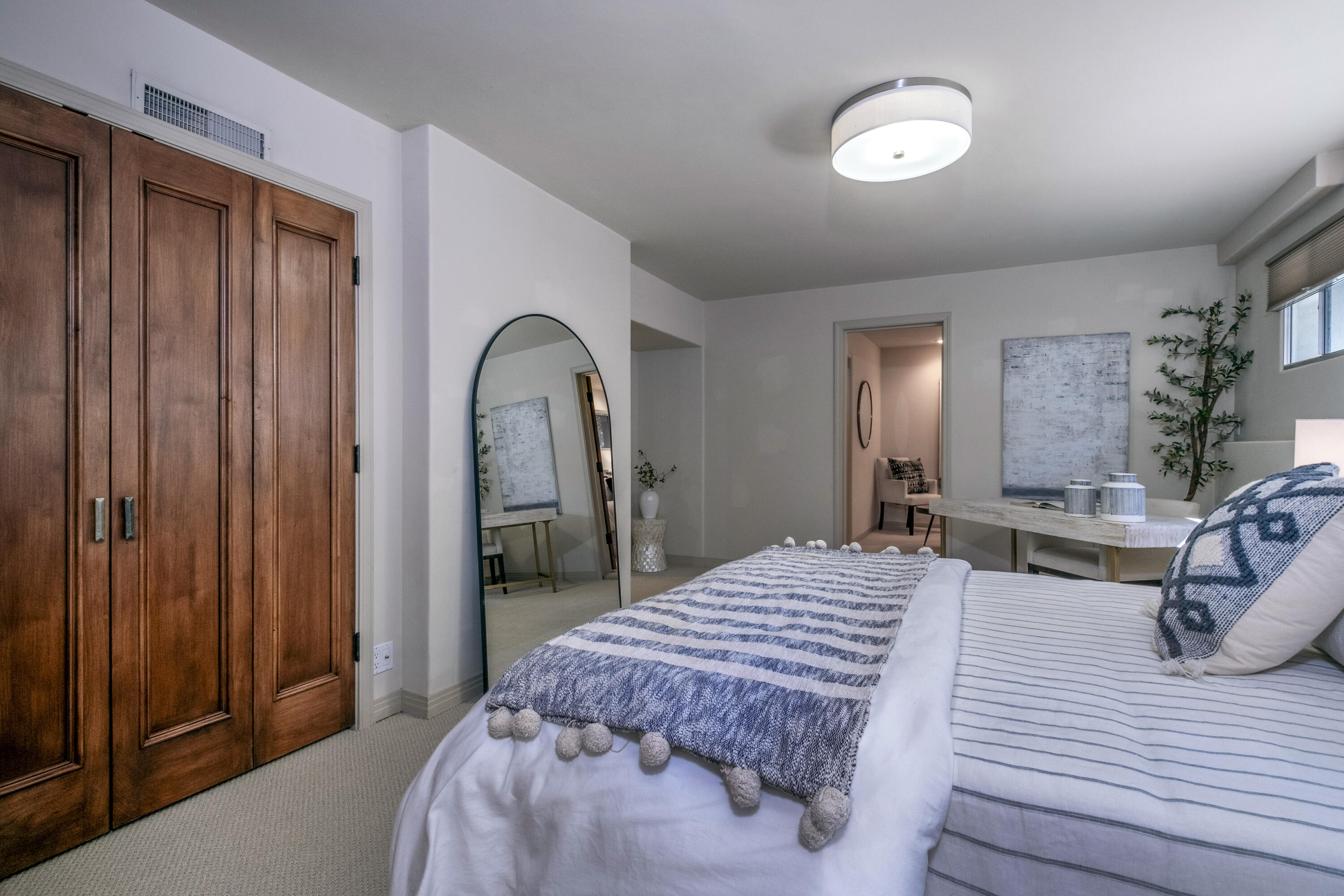 985 Monte Drive Santa Barbara, CA 93110 - Photo 18 of 29 a bed sitting in a spacious bedroom next to a window and a mirror