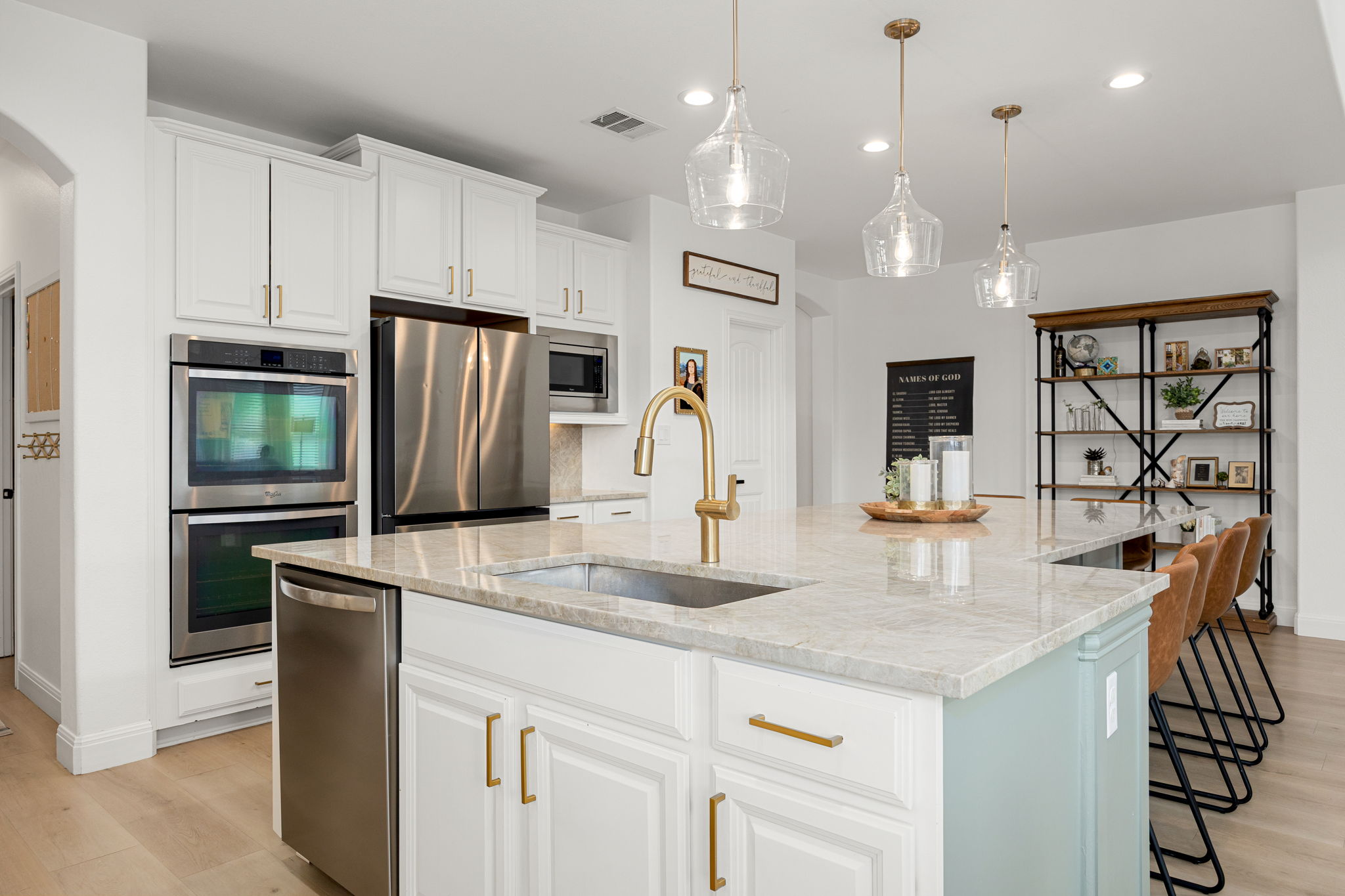 225 Pettigrew Path Buda, TX 78610 - Photo 11 of 38 a kitchen with stainless steel appliances granite countertop a sink a stove and a refrigerator