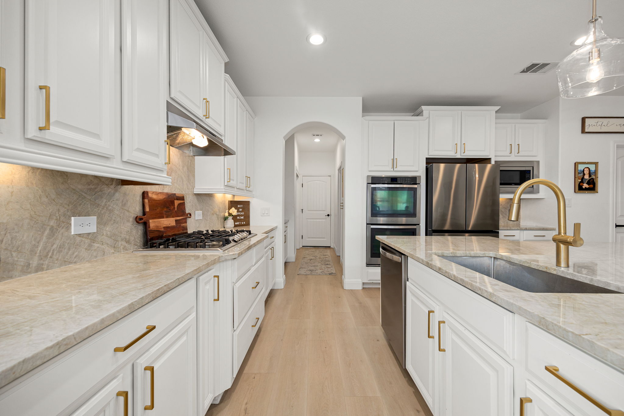 225 Pettigrew Path Buda, TX 78610 - Photo 12 of 38 a kitchen with stainless steel appliances granite countertop a sink stove and refrigerator