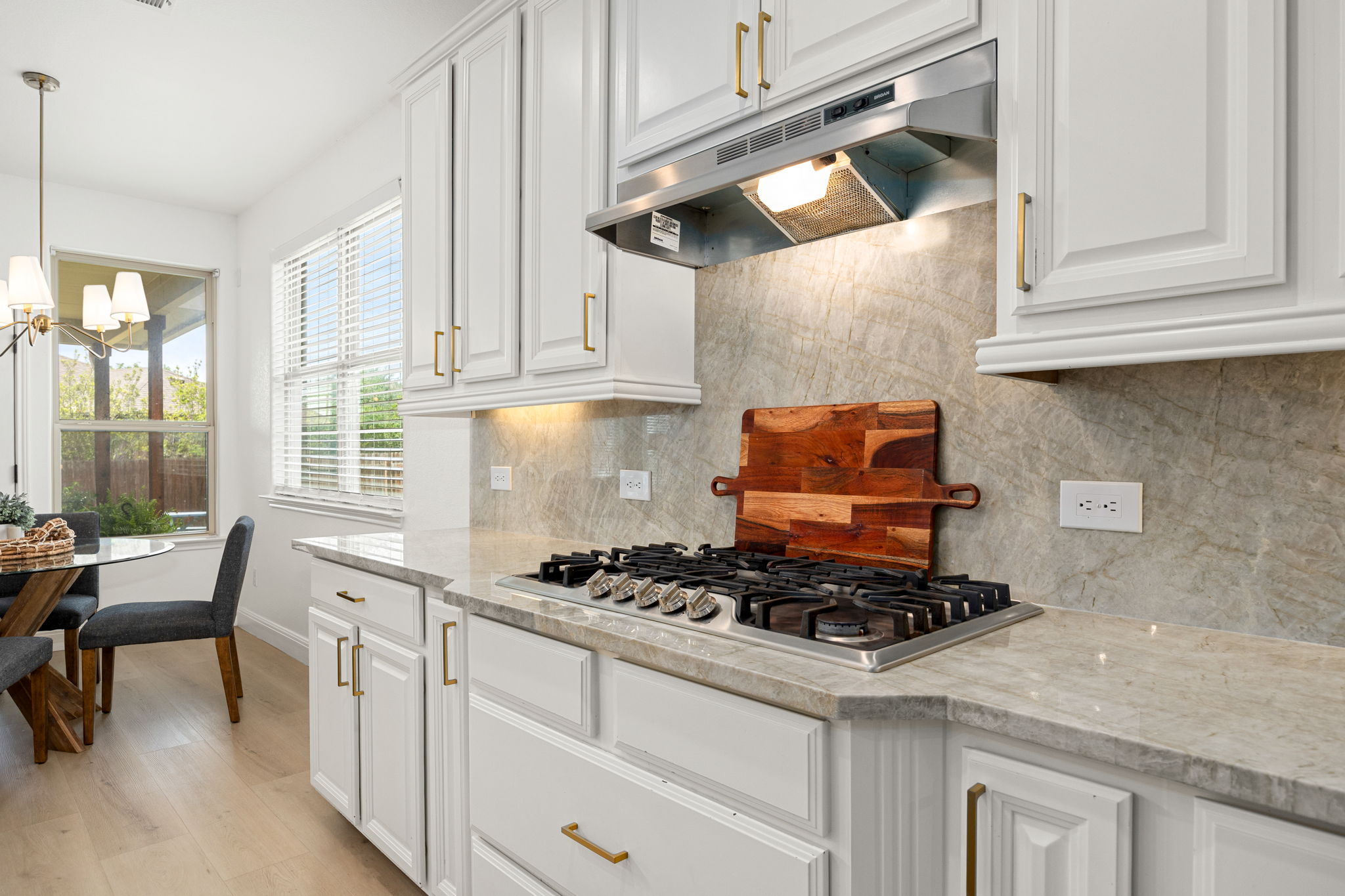 225 Pettigrew Path Buda, TX 78610 - Photo 13 of 38 a kitchen with stainless steel appliances granite countertop a stove and a white cabinets