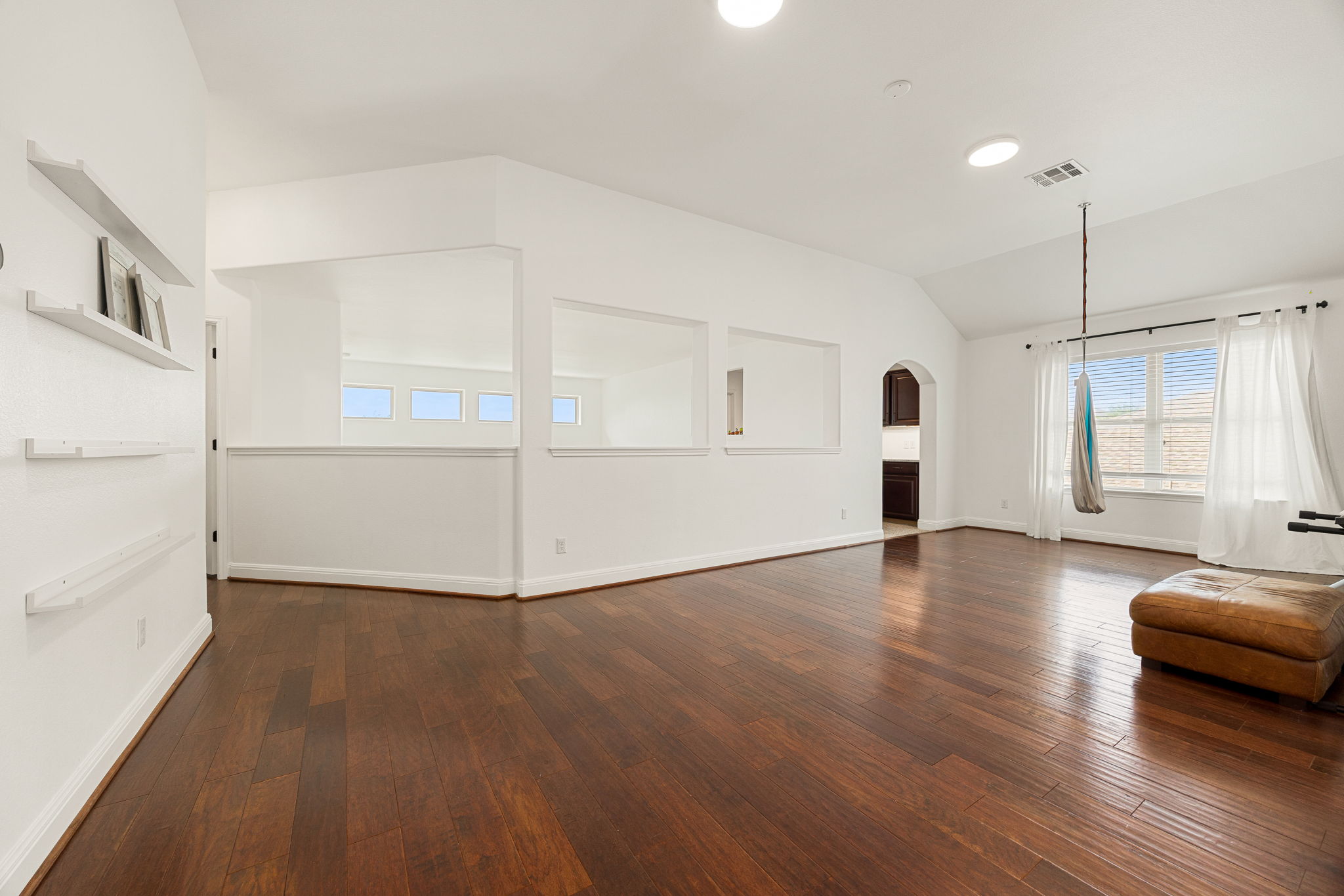 225 Pettigrew Path Buda, TX 78610 - Photo 22 of 38 a view of empty room with wooden floor and fan