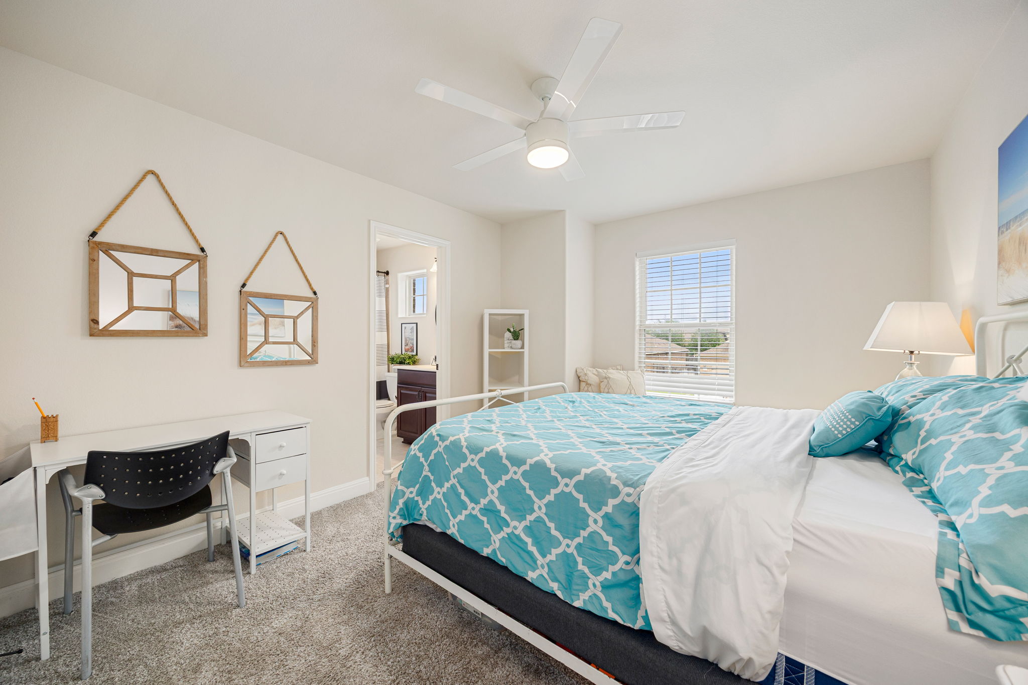 225 Pettigrew Path Buda, TX 78610 - Photo 29 of 38 a bedroom with a bed a chair and dresser