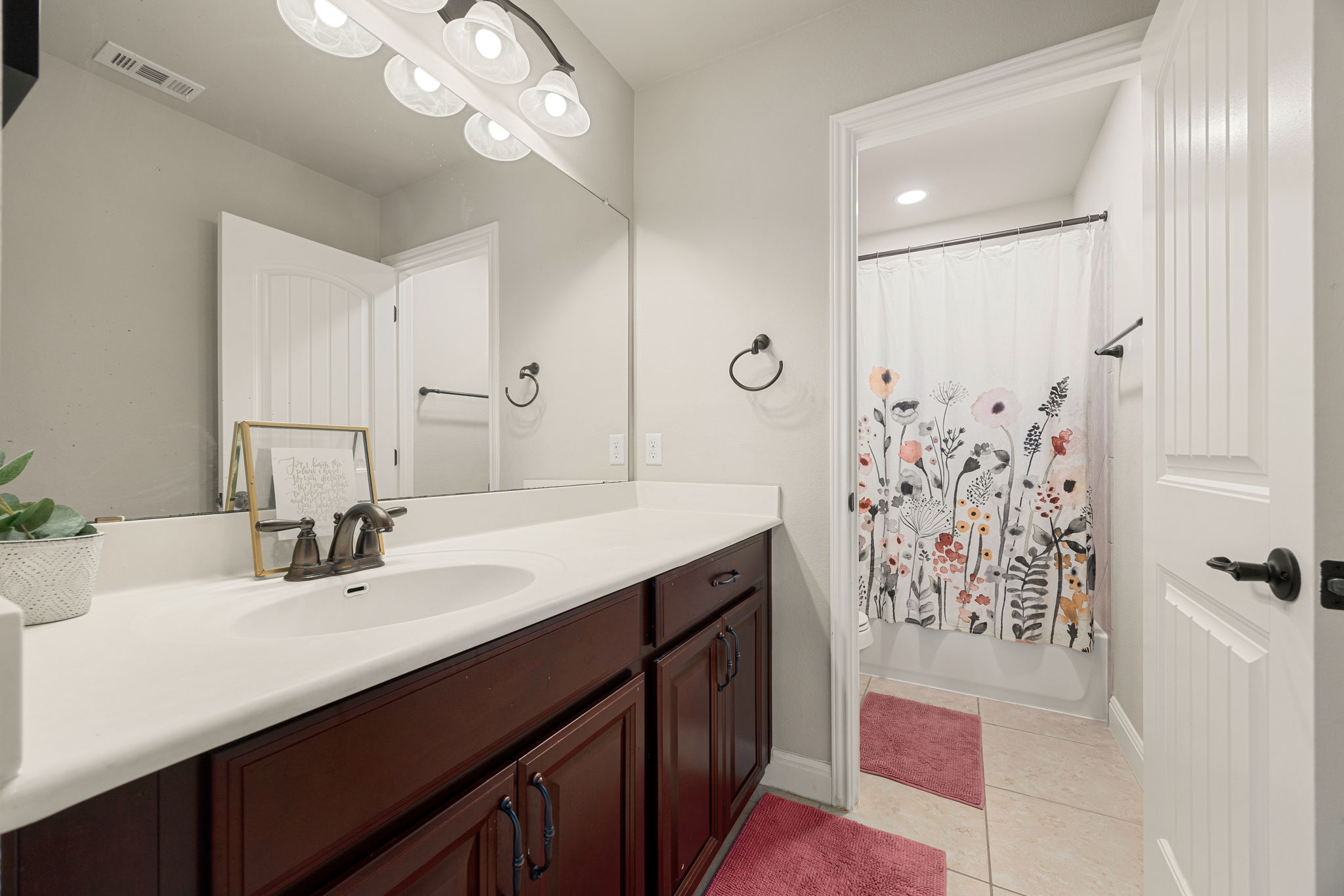225 Pettigrew Path Buda, TX 78610 - Photo 31 of 38 a bathroom with a double vanity sink mirror and shower
