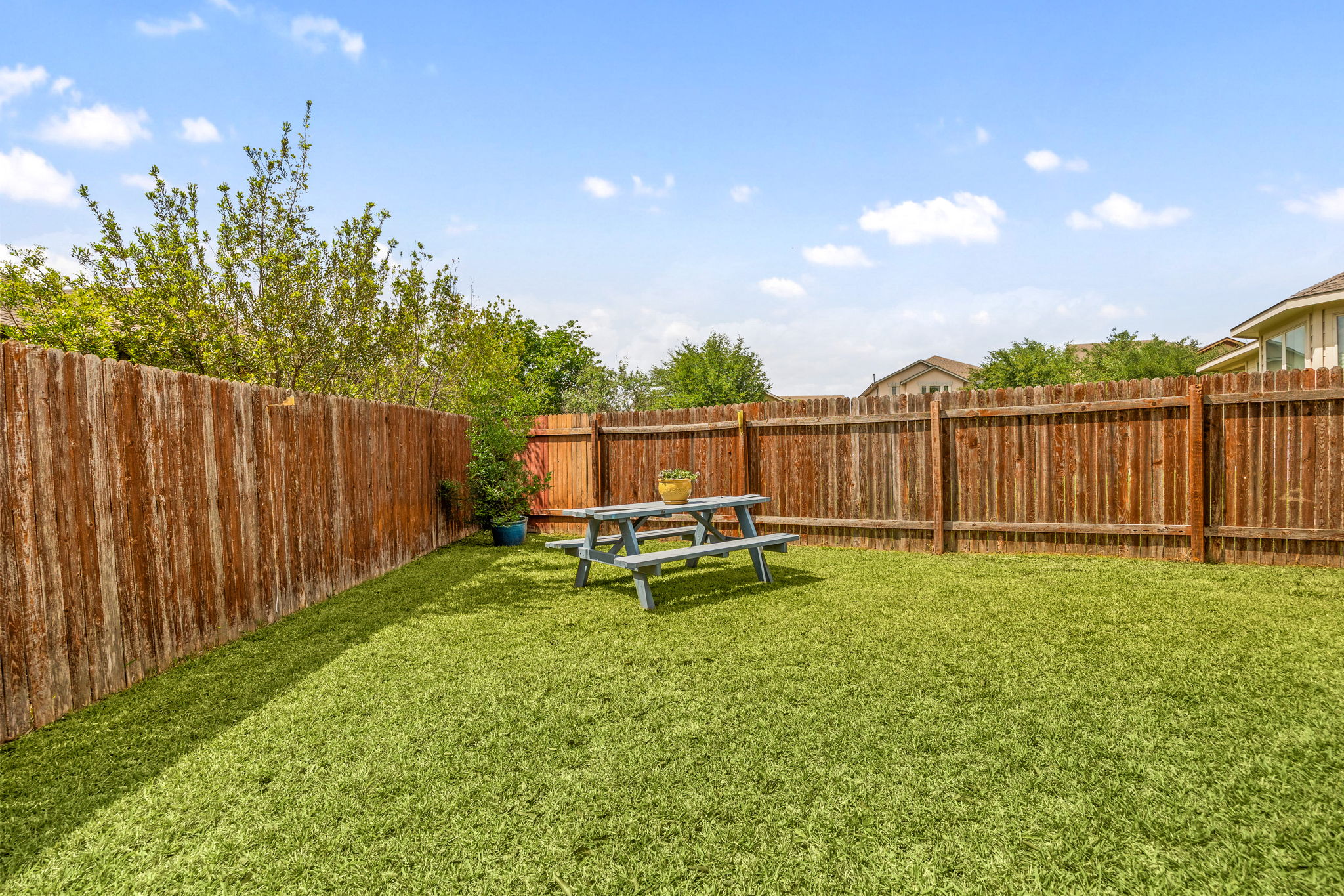 225 Pettigrew Path Buda, TX 78610 - Photo 35 of 38 a backyard of a house with table and chairs