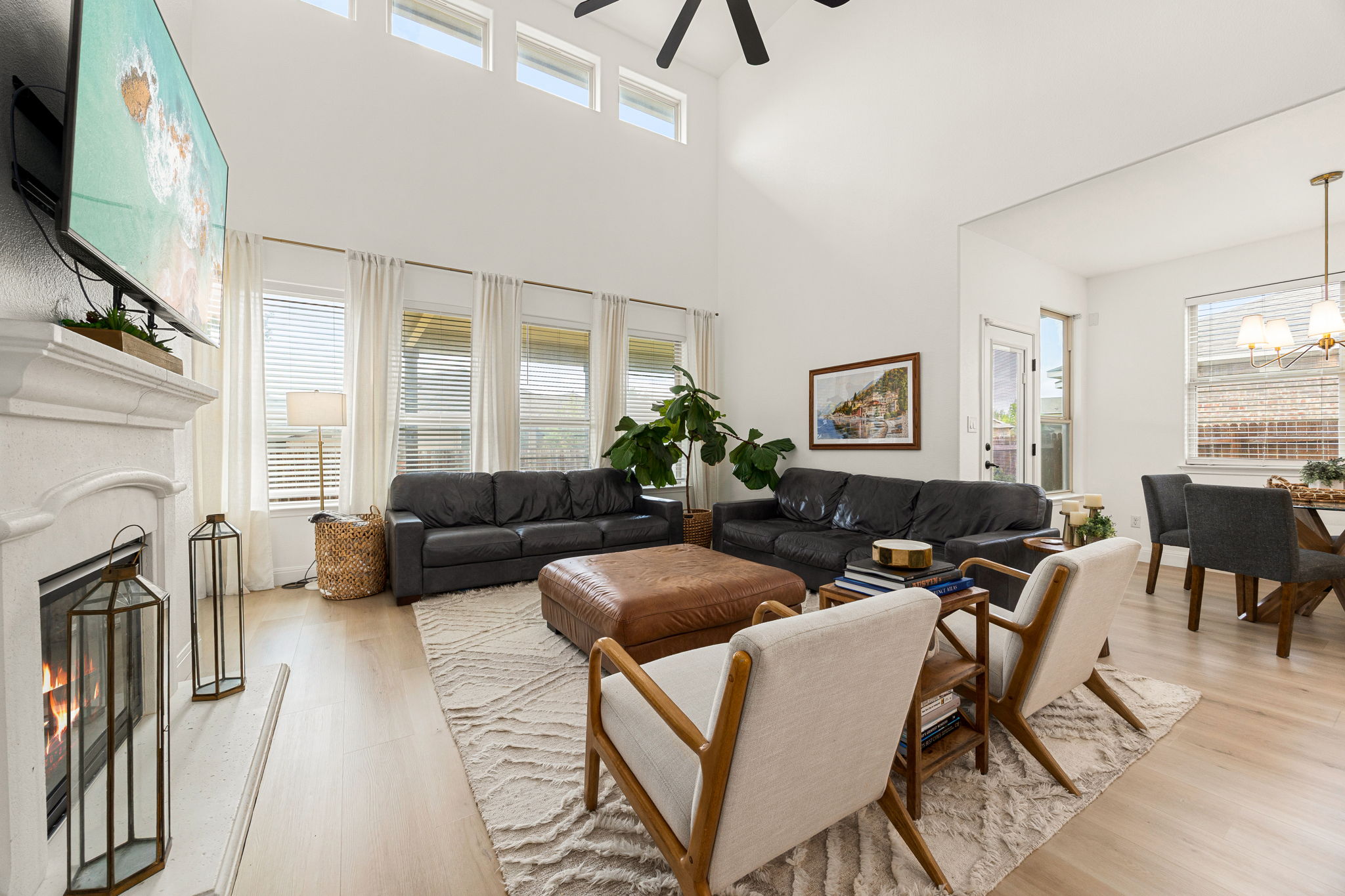225 Pettigrew Path Buda, TX 78610 - Photo 7 of 38 a living room with furniture a fireplace and a flat screen tv