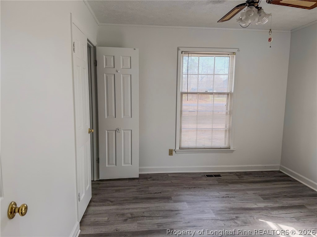 575 Veterans Road St. Pauls, NC 28384 - Photo 8 of 27 a view of an empty room with wooden floor and a window