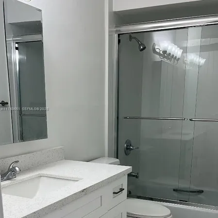a bathroom with a sink and mirror
