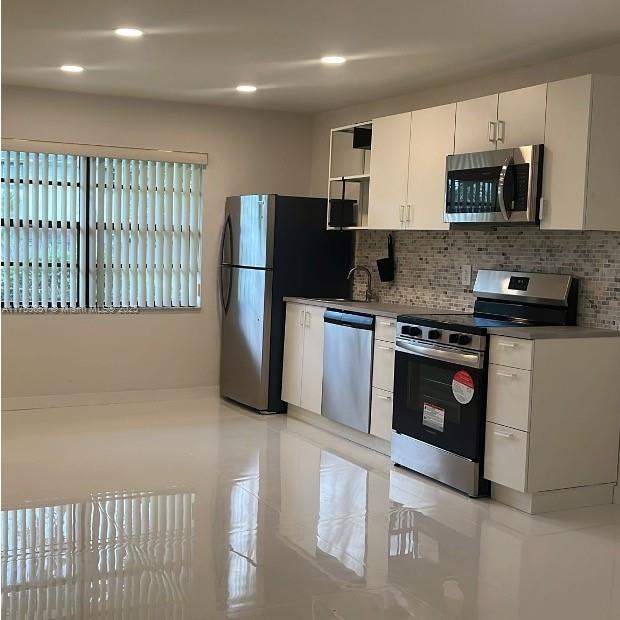 2307 Taylor Street, Unit 205 Hollywood, FL 33020 - Photo 3 of 4 a kitchen with stainless steel appliances granite countertop a refrigerator and a stove top oven