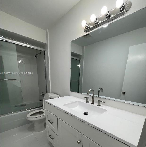 2307 Taylor Street, Unit 205 Hollywood, FL 33020 - Photo 4 of 4 a bathroom with a toilet a sink and mirror