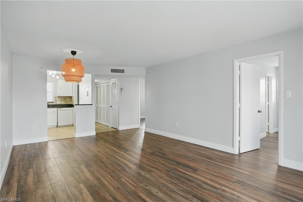 170 Turtle Lake Court, Unit 301 Naples, FL 34105 - Photo 1 of 23 a view of empty room with wooden floor