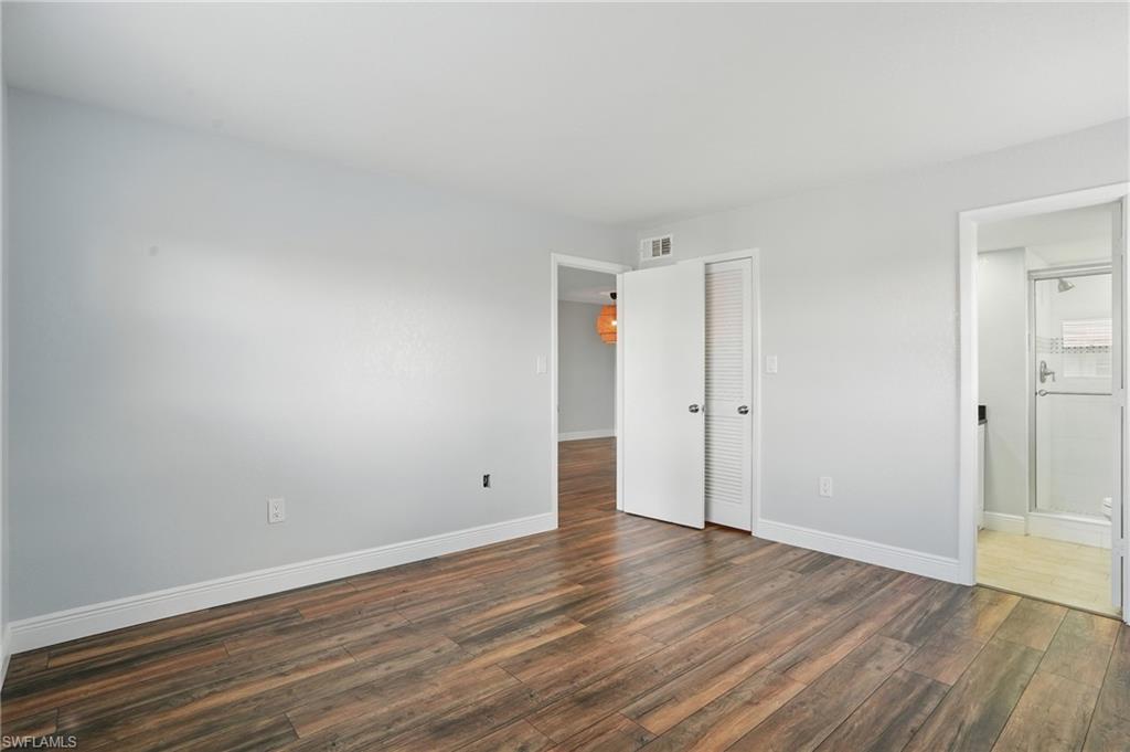170 Turtle Lake Court, Unit 301 Naples, FL 34105 - Photo 12 of 23 a view of an empty room with wooden floor