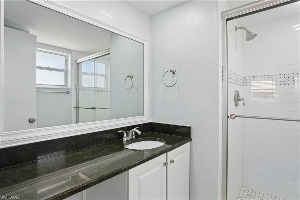 170 Turtle Lake Court, Unit 301 Naples, FL 34105 - Photo 13 of 23 a bathroom with a sink and a mirror