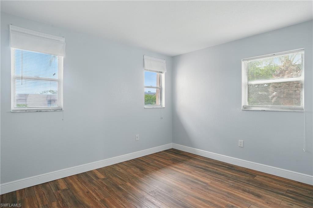 170 Turtle Lake Court, Unit 301 Naples, FL 34105 - Photo 15 of 23 a view of a room that has wooden floor and window in it