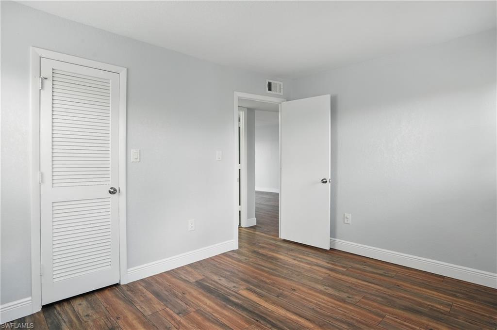 170 Turtle Lake Court, Unit 301 Naples, FL 34105 - Photo 16 of 23 a view of an empty room with wooden floor