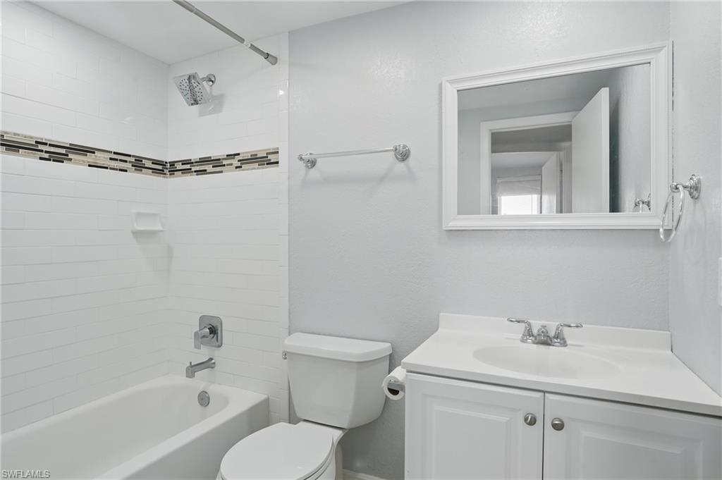 170 Turtle Lake Court, Unit 301 Naples, FL 34105 - Photo 17 of 23 a bathroom with a sink toilet and shower