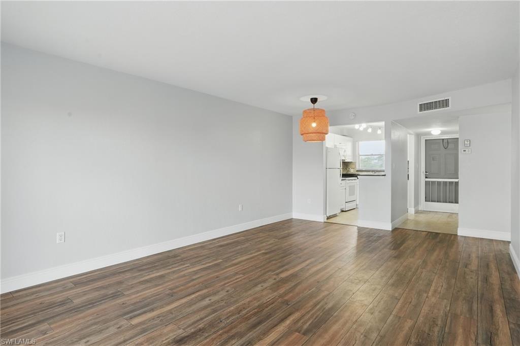 170 Turtle Lake Court, Unit 301 Naples, FL 34105 - Photo 4 of 23 a view of empty room with wooden floor