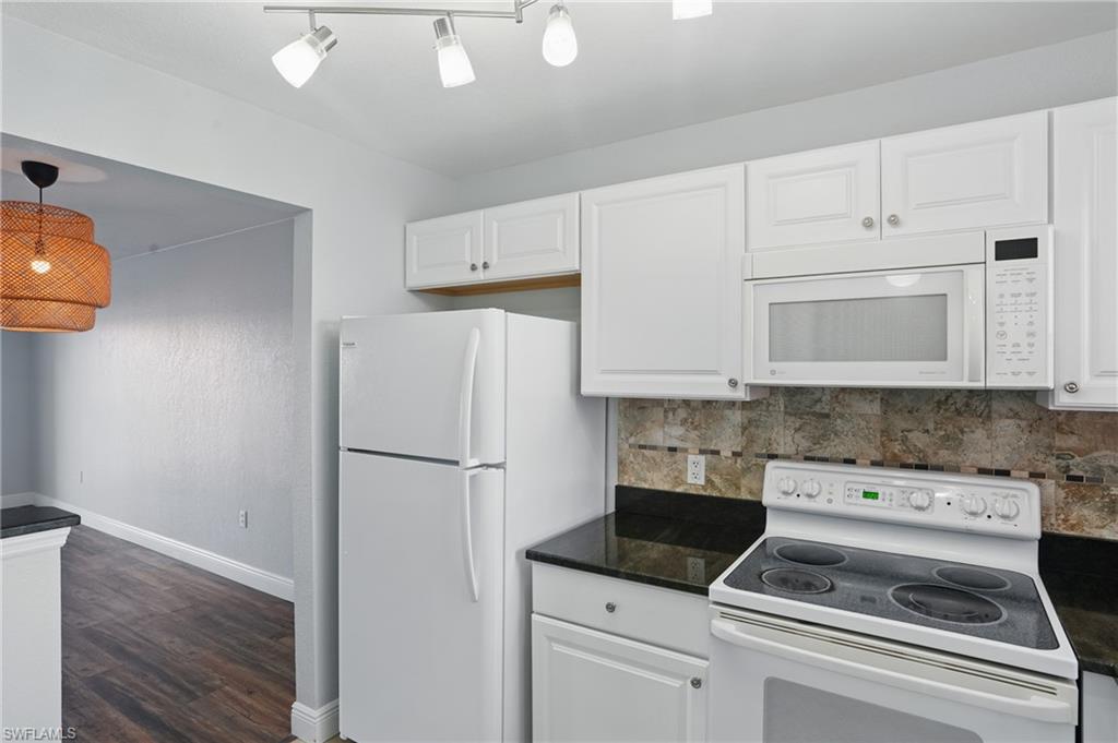 170 Turtle Lake Court, Unit 301 Naples, FL 34105 - Photo 8 of 23 a kitchen with appliances and cabinets
