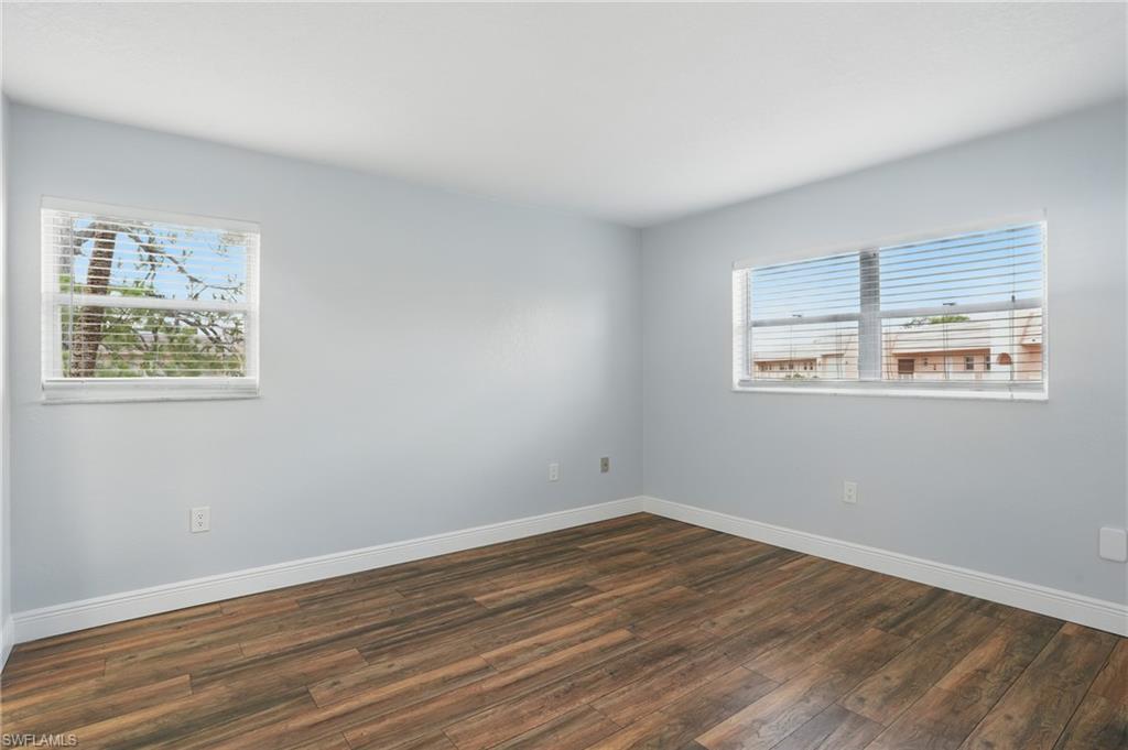 170 Turtle Lake Court, Unit 301 Naples, FL 34105 - Photo 10 of 23 a view of a room with wooden floor and windows