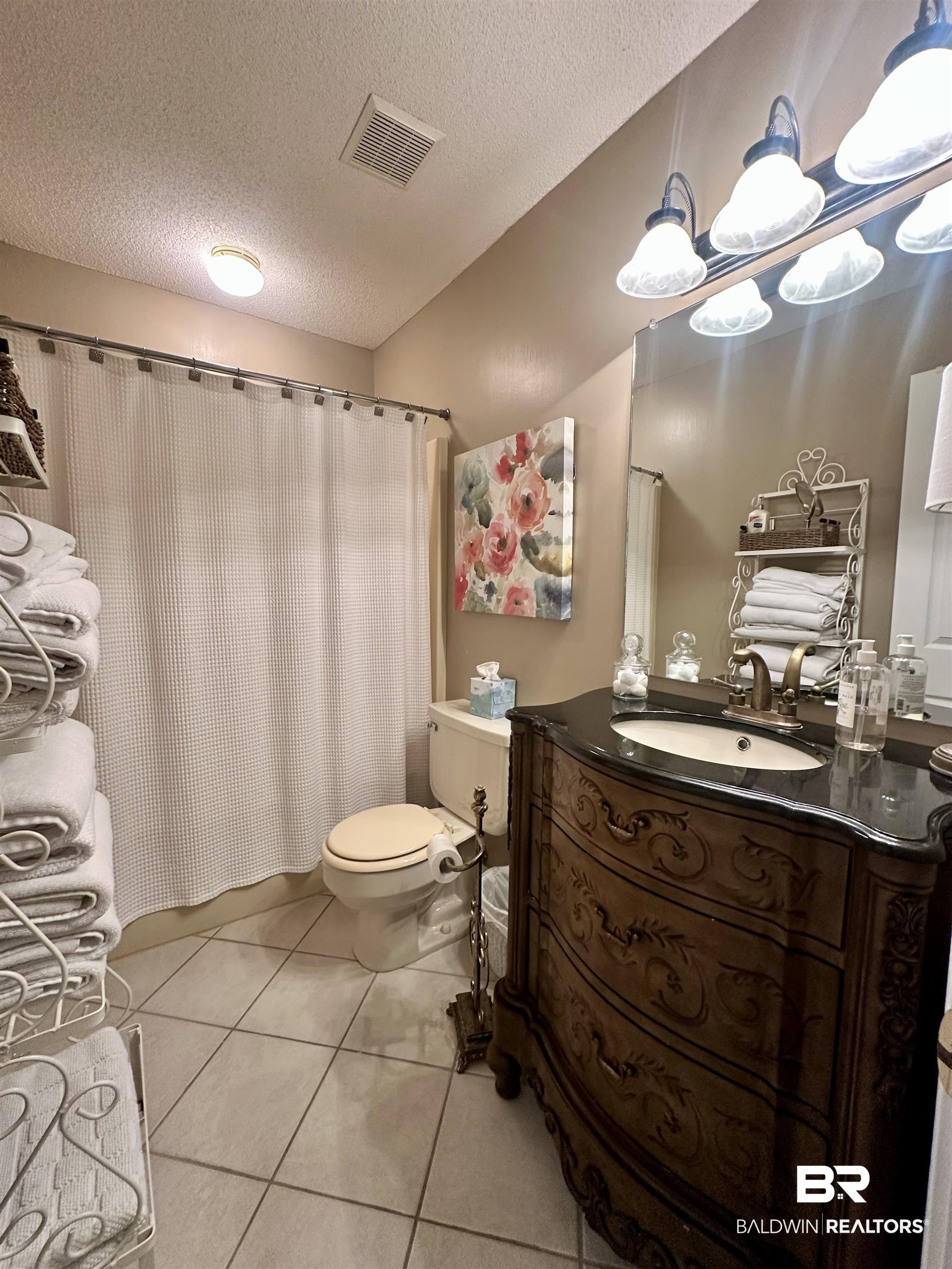 148 Brooks Boulevard Brewton, AL 36426 - Photo 28 of 45 Bathroom featuring tile patterned floors, visible vents, toilet, a textured ceiling, and vanity