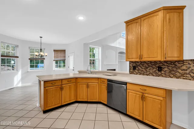 a large kitchen with stainless steel appliances granite countertop a sink and cabinets