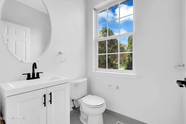 a bathroom with a toilet sink and window