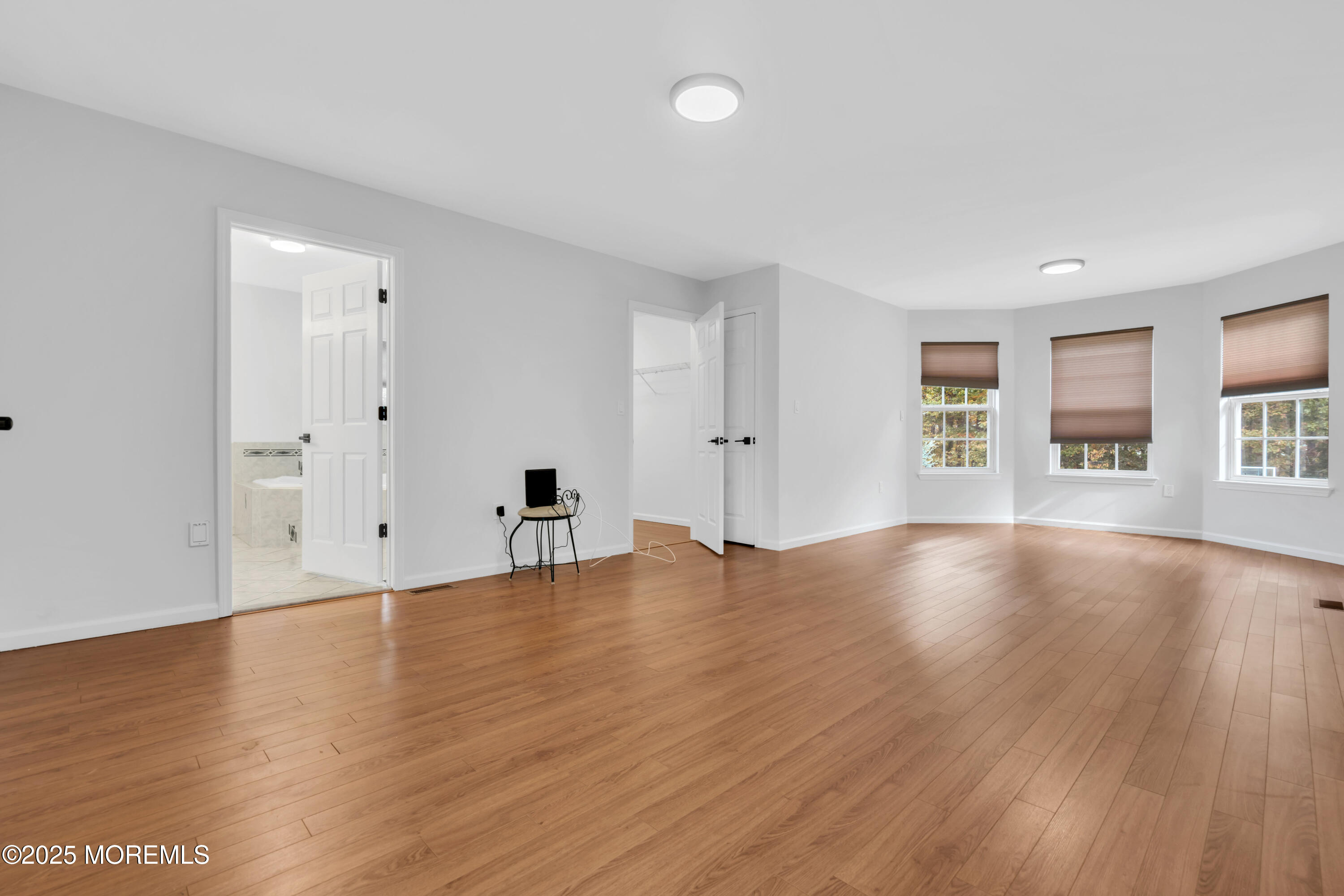3 Wellesly Court Jackson, NJ 08527 - Photo 21 of 35 a view of an empty room with window and wooden floor