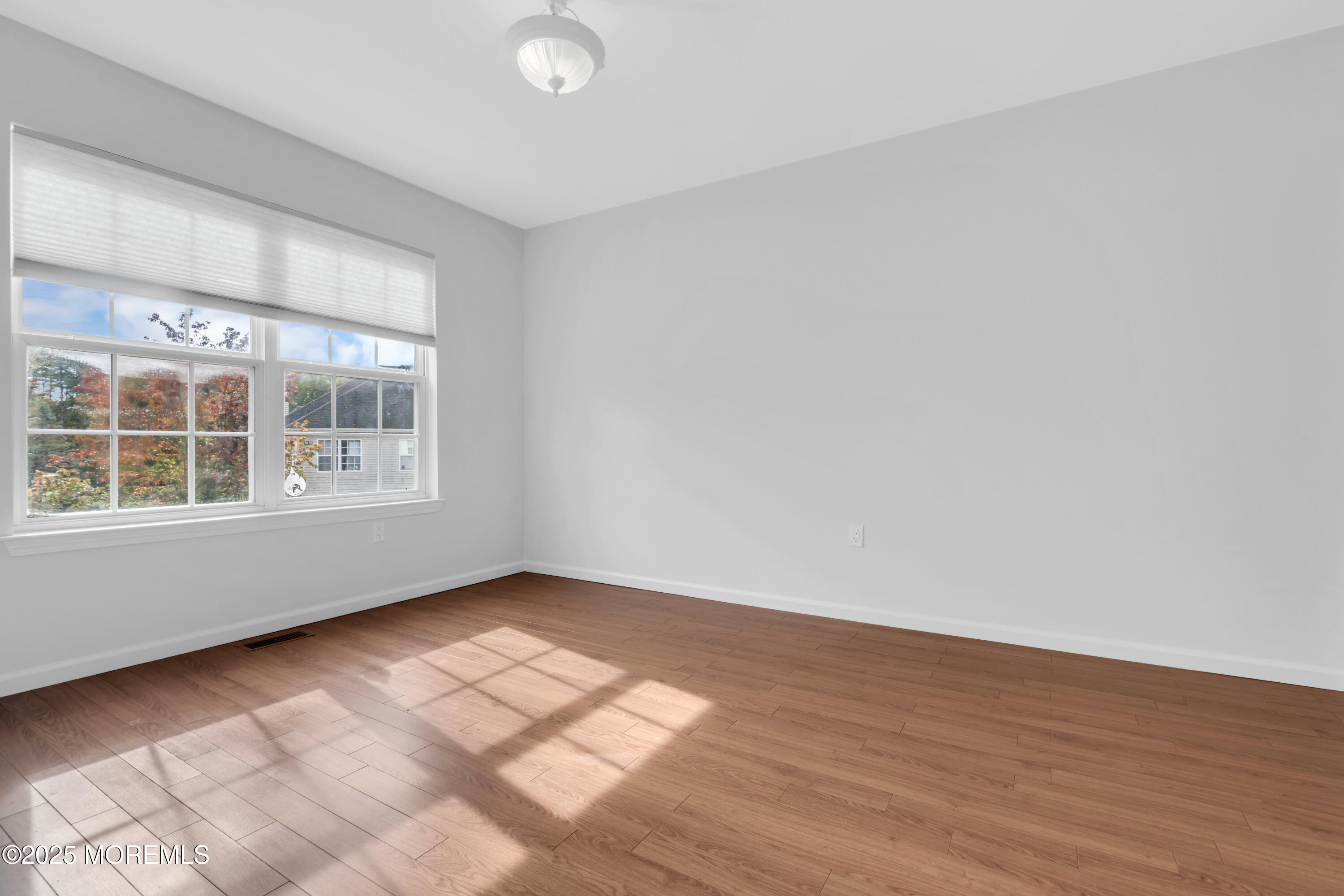 3 Wellesly Court Jackson, NJ 08527 - Photo 27 of 35 an empty room with wooden floor and windows