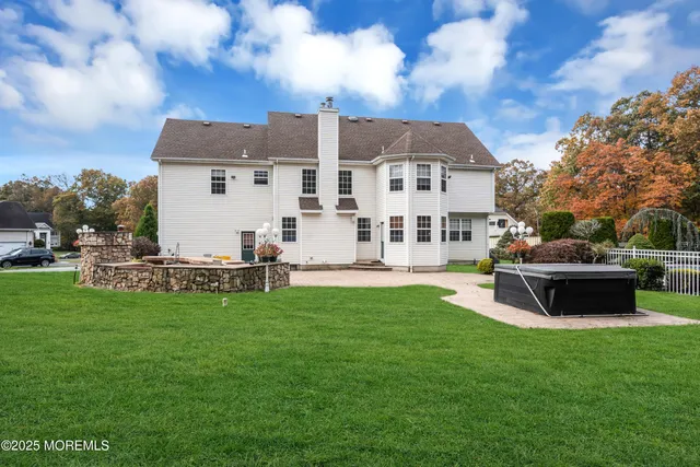 a view of a house with backyard sitting area and garden