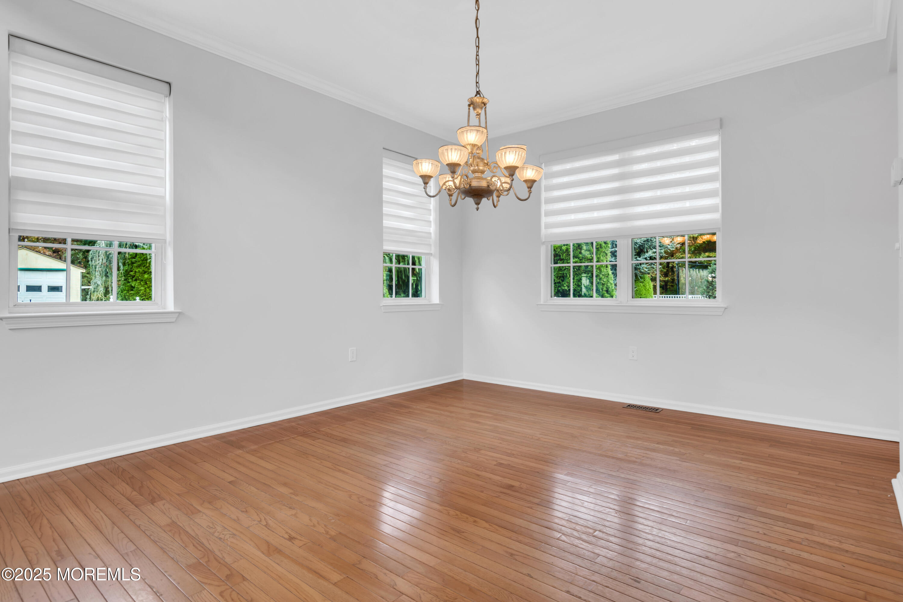 3 Wellesly Court Jackson, NJ 08527 - Photo 8 of 35 a view of an empty room with wooden floor and a window