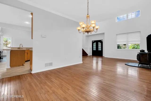 a view of a room with wooden floor and kitchen space