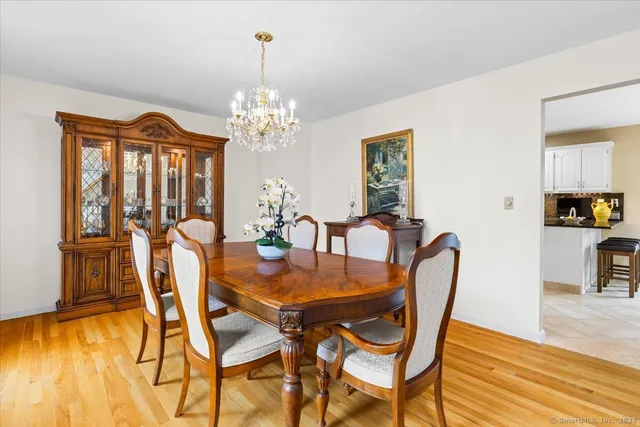 a view of a dining room with furniture wooden floor and chandelier