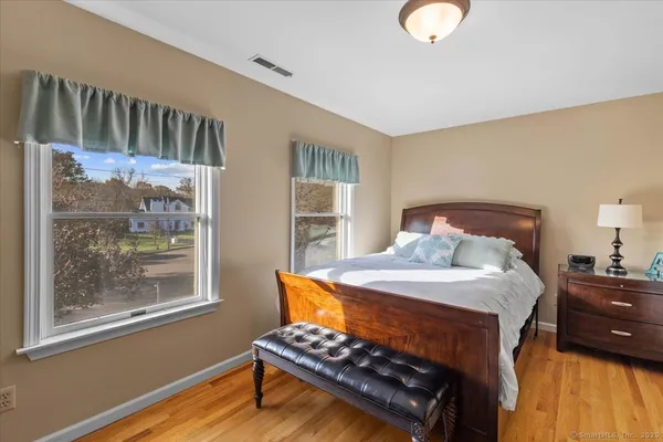 a bedroom with a bed next to a window