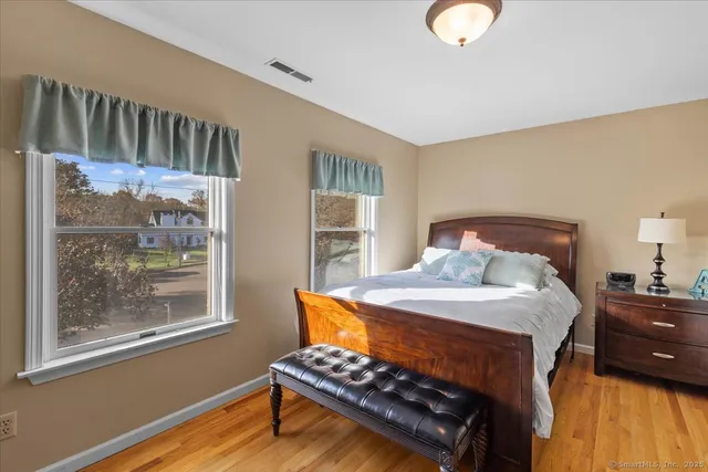 a bedroom with a bed next to a window