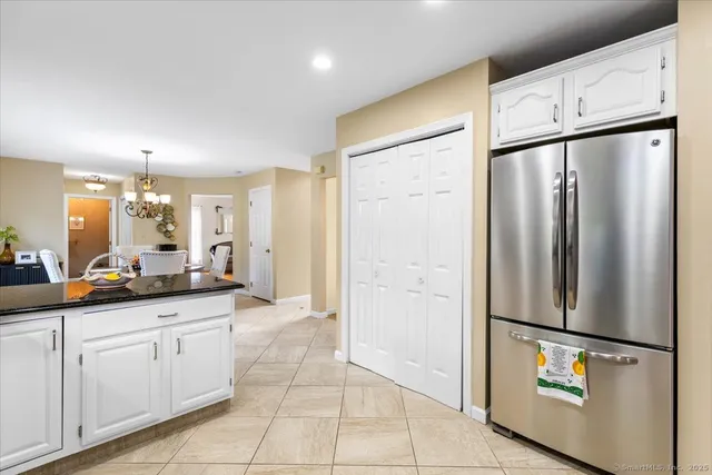 a kitchen with stainless steel appliances a refrigerator sink and cabinets