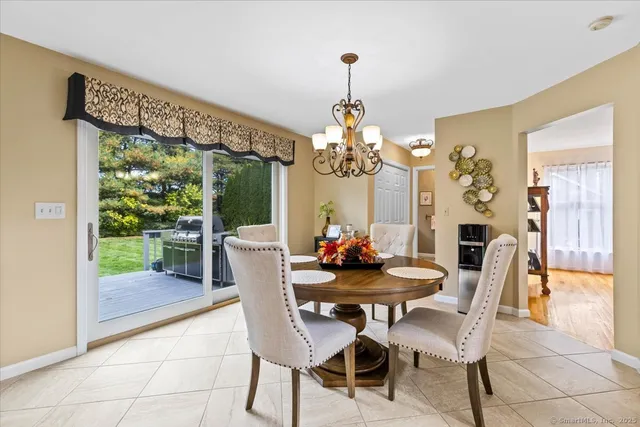 a dining room with furniture a chandelier and a rug