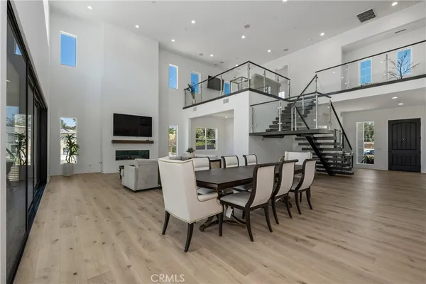 a dining room with furniture and wooden floor
