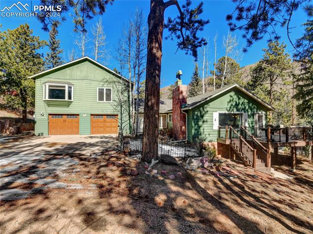 4955 Dodd Road Cascade, CO 80809 - Photo 2 of 45 View of front facade featuring a garage and a deck