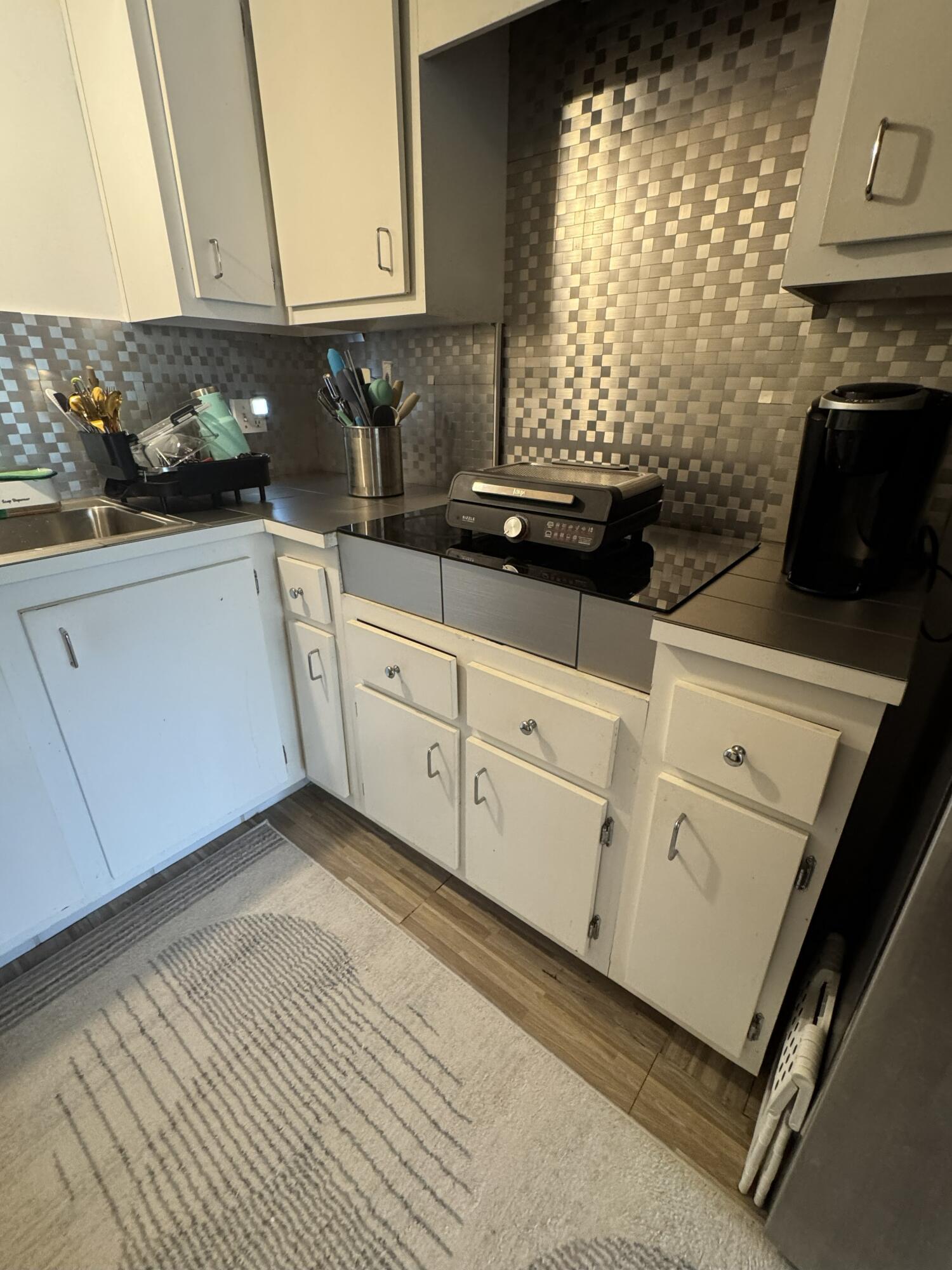 5961 North Falls Cir Drive, Unit 306 Lauderhill, FL 33319 - Photo 1 of 16 a kitchen with white cabinets and window