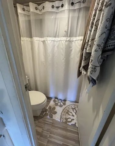 a bathroom with a sink toilet and mirror