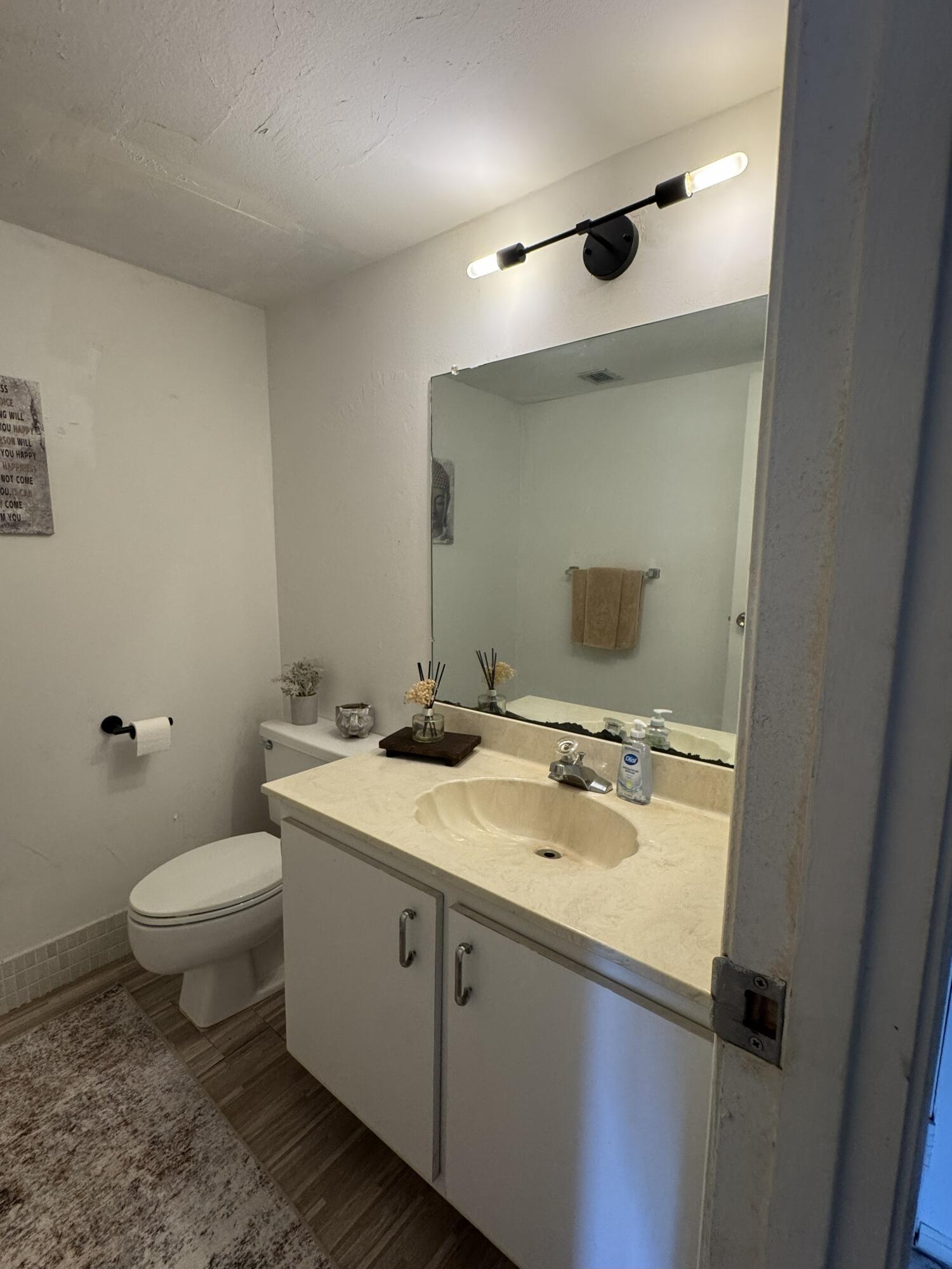 5961 North Falls Cir Drive, Unit 306 Lauderhill, FL 33319 - Photo 12 of 16 a bathroom with a sink toilet and mirror