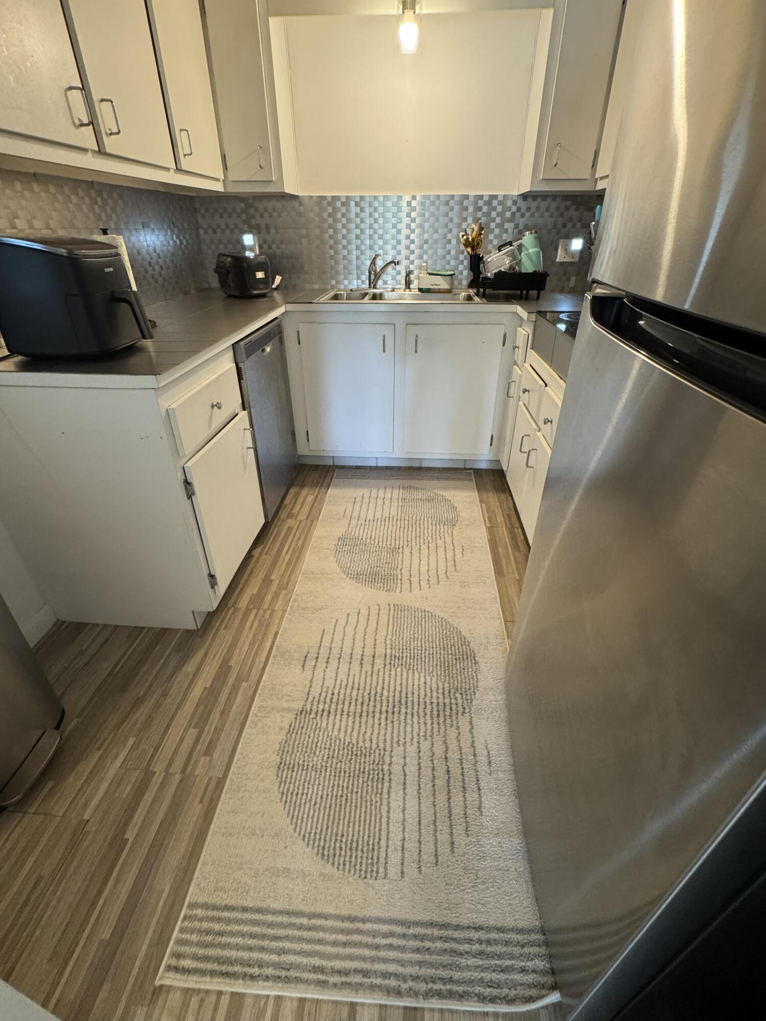 5961 North Falls Cir Drive, Unit 306 Lauderhill, FL 33319 - Photo 4 of 16 a view of washer and dryer with wooden floor