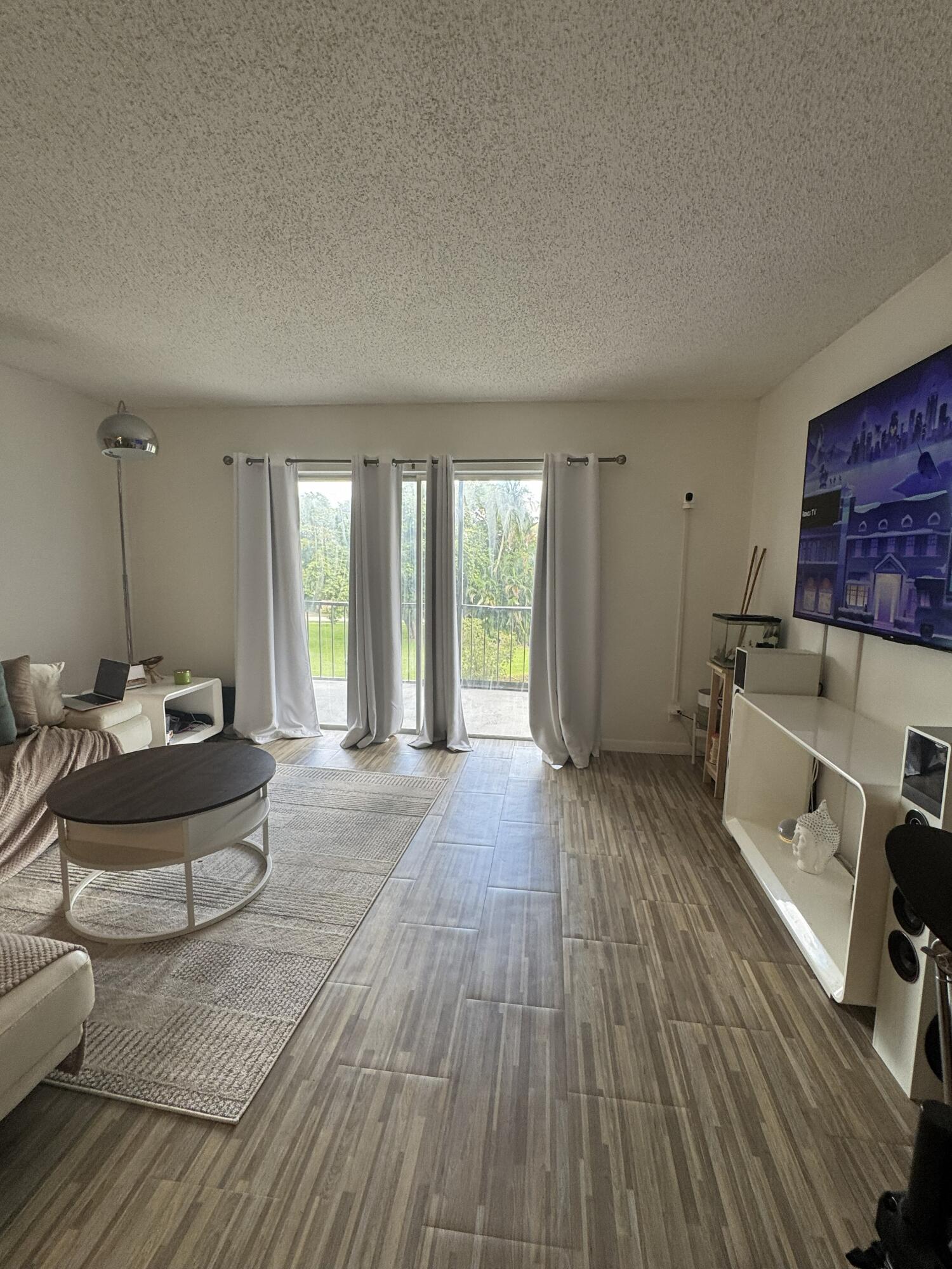 5961 North Falls Cir Drive, Unit 306 Lauderhill, FL 33319 - Photo 6 of 16 a living room with furniture and a wooden floor