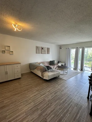 a spacious bedroom with a bed and a flat screen tv