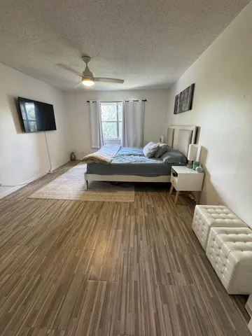 a view of a living room with furniture and wooden floor